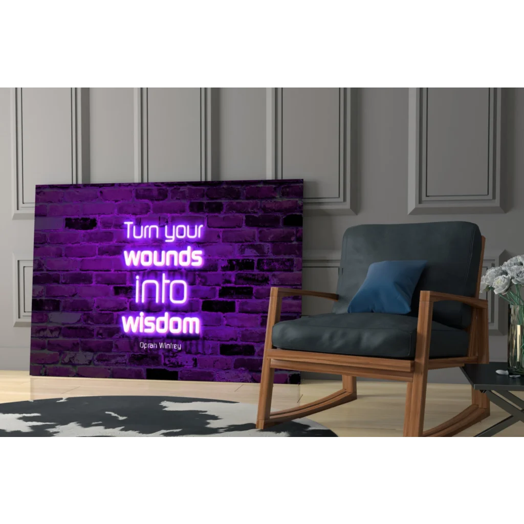 Purple neon glass wall art of Oprah Winfrey quote on brick wall