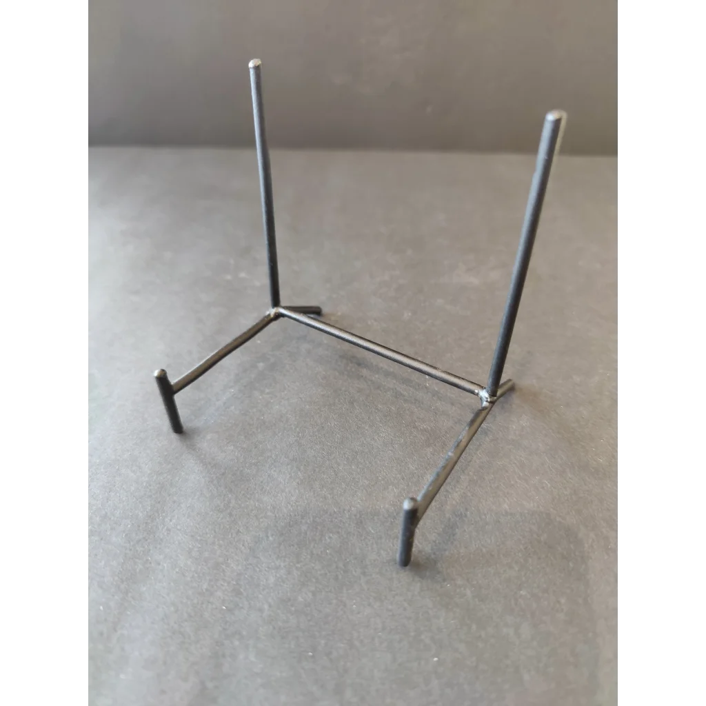 Sleek wrought iron black display stand for retail showcases