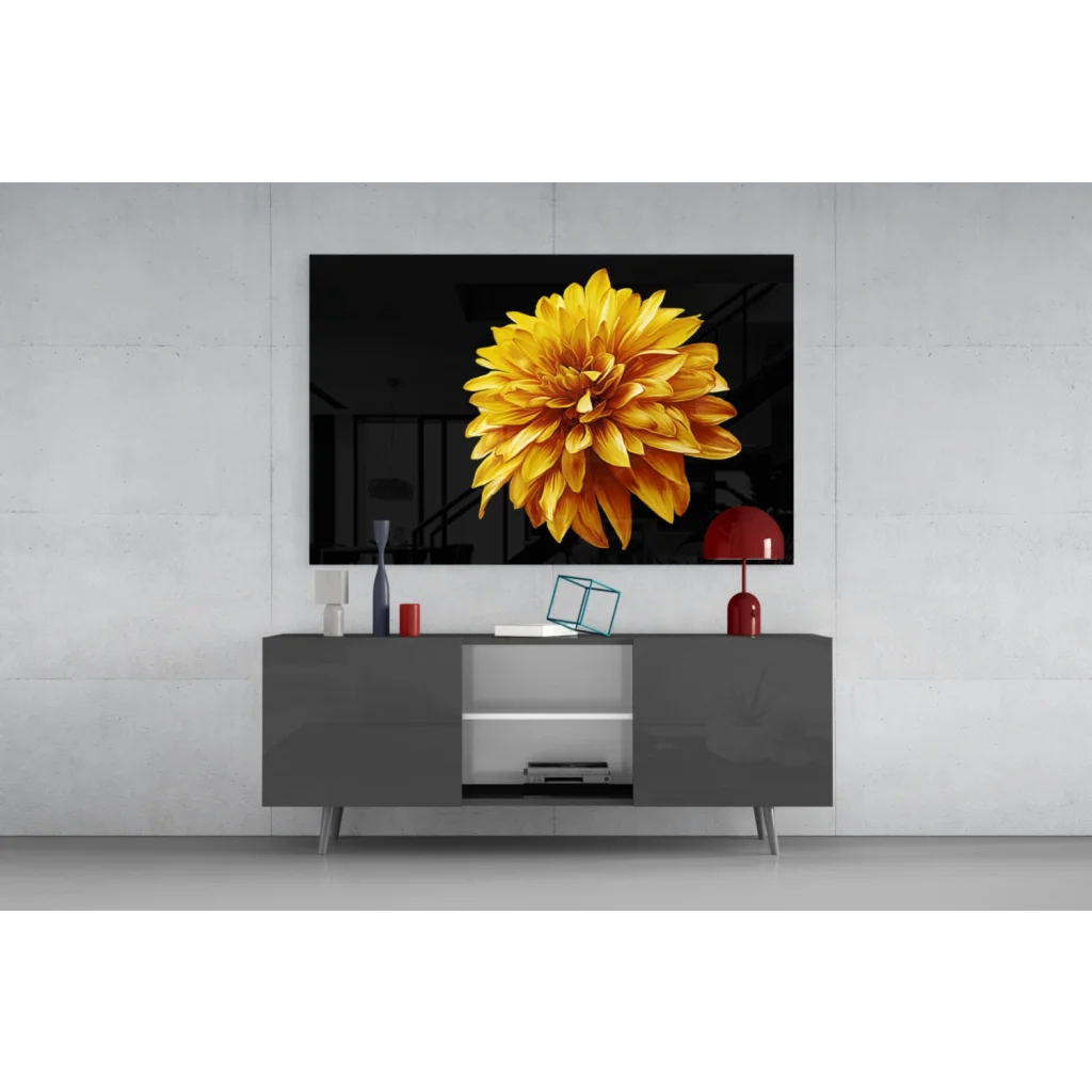 Vibrant yellow dahlia wall art on sleek black wall above gray console