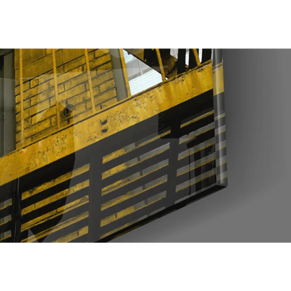 Yellow black striped safety railing on reflective glass wall art