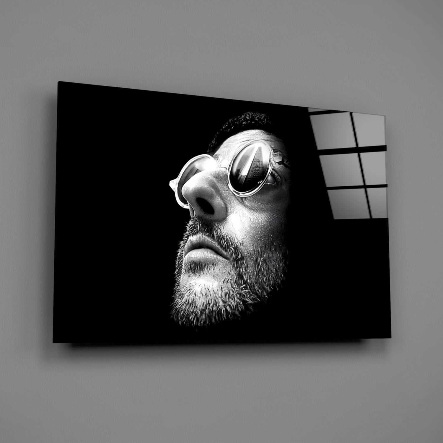 Black and white portrait of bearded man wearing sunglasses printed on glass wall art with window grid visible on right edge.