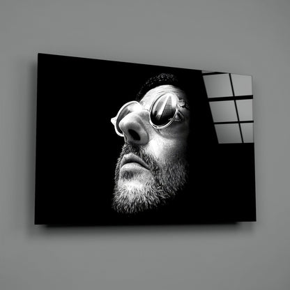 Black and white portrait of bearded man wearing sunglasses printed on glass wall art with window grid visible on right edge.
