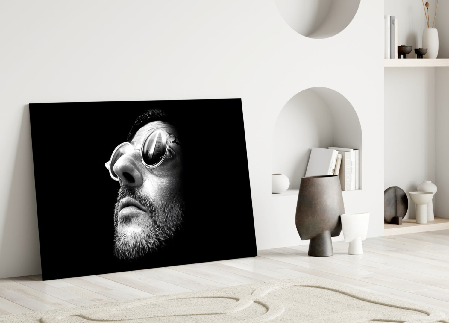 Black and white portrait glass art of bearded man wearing sunglasses displayed in minimalist white interior space.