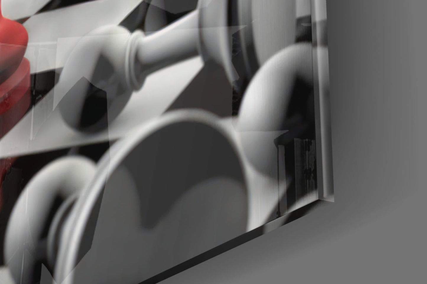 Close-up detail of white and black curved glass panels with red accent visible on left edge.