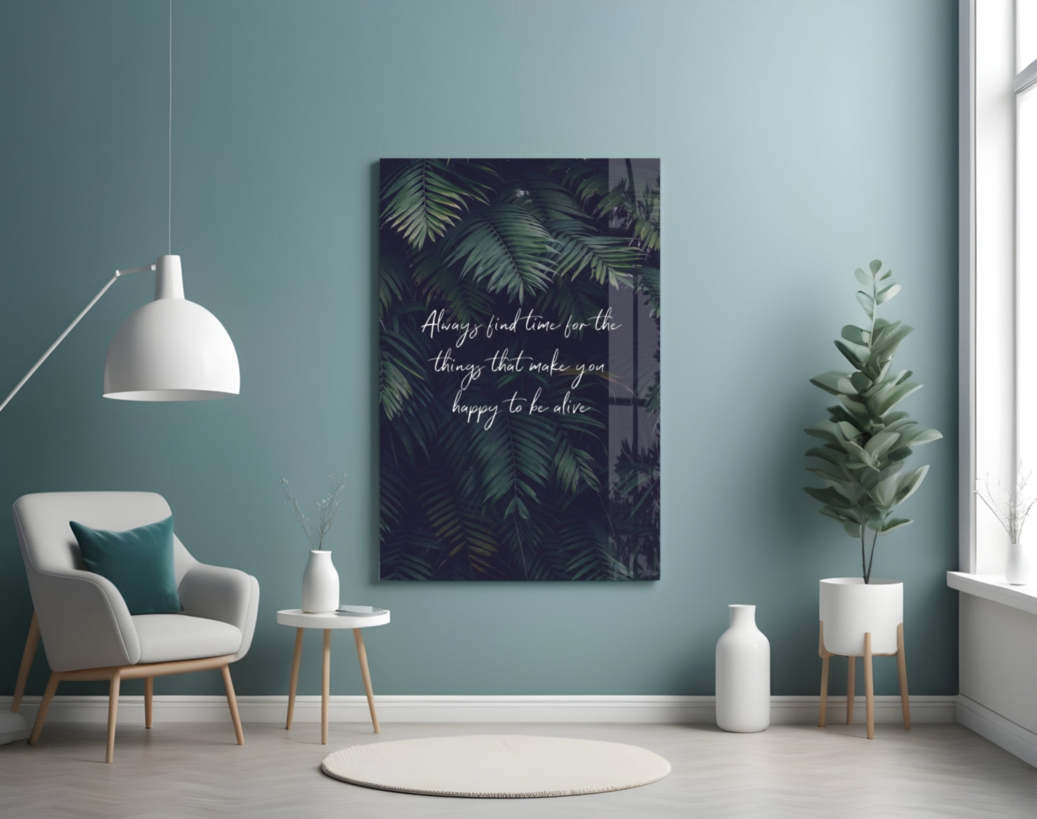 Glass wall art with dark foliage background and white motivational text displayed in a minimalist turquoise room setting.