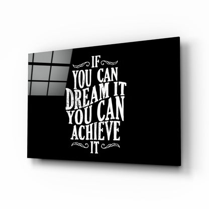 Black glass wall art panel with white inspirational text "If You Can Dream It You Can Achieve It" displayed at an angle against white background.