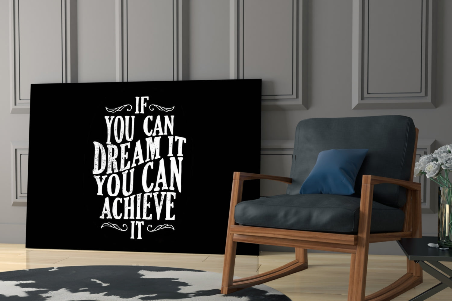 Black glass wall art with white inspirational text displayed in a modern living room beside a wooden chair with blue cushions.