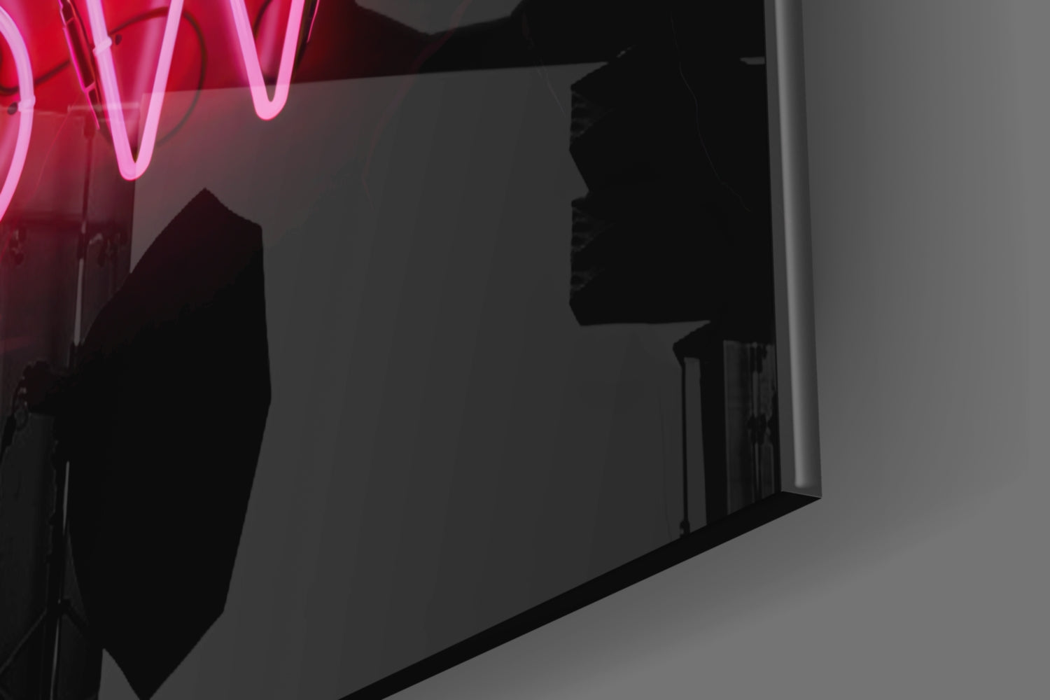 Pink neon "Now" sign glowing above dark silhouettes in minimalist interior space.