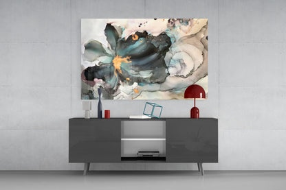 Abstract glass wall art with fluid watercolor design in teal, navy, gold, and cream tones displayed above dark modern console table.