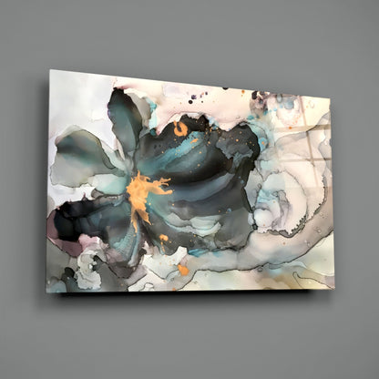 Abstract marble flower glass wall art featuring swirling teal, black, orange, and cream tones displayed at an angle against gray background.