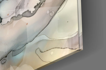 Close-up overhead view of layered glass wall art with organic curved lines in gray and beige tones on cream background.