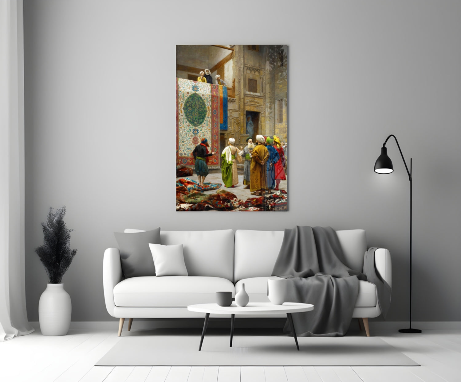 Orientalist painting on glass depicting figures in colorful robes examining carpets in an ornate interior courtyard, displayed above a white sofa in a modern living room.