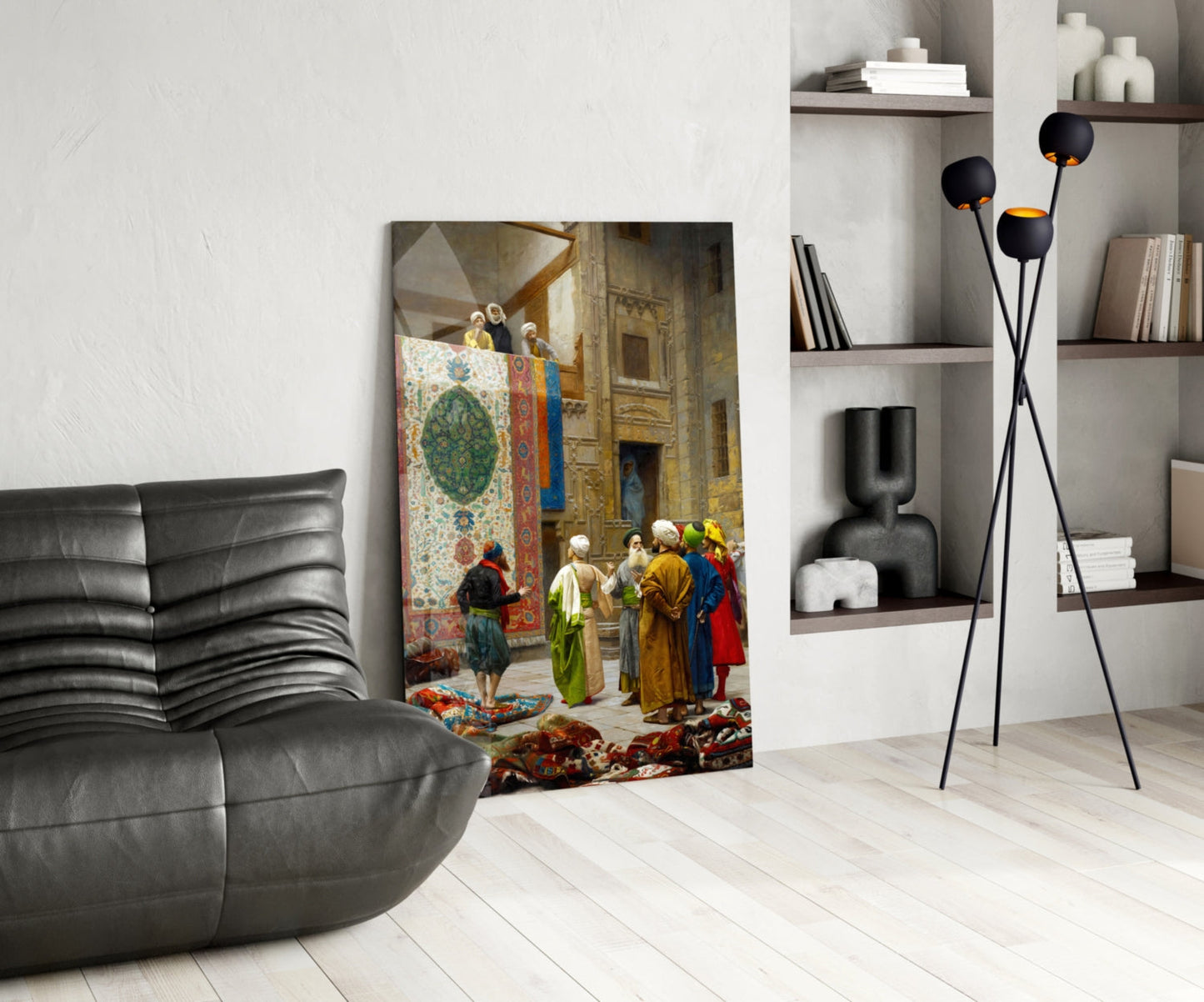 Glass wall art depicting a Middle Eastern bazaar scene with figures in colorful robes examining ornate carpets and textiles, displayed in a modern living room setting.