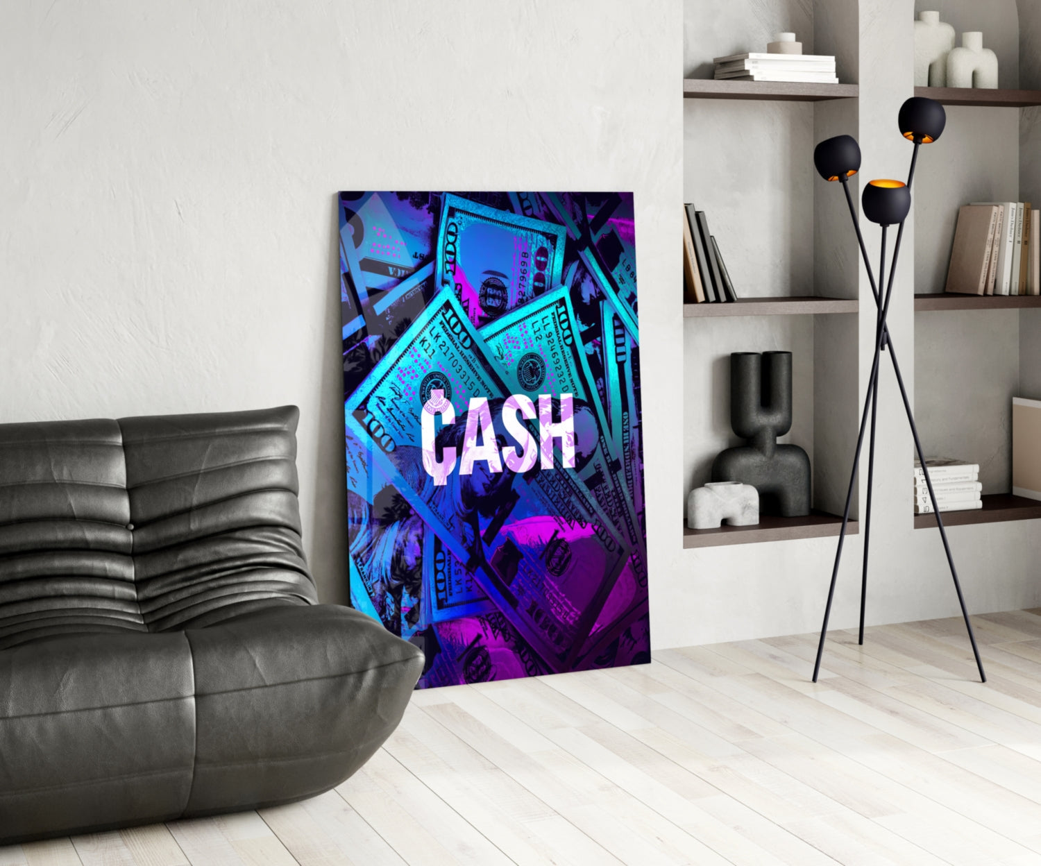 Neon "CASH" glass wall art with cyan and magenta dollar bill design displayed in modern living room next to black leather sofa.