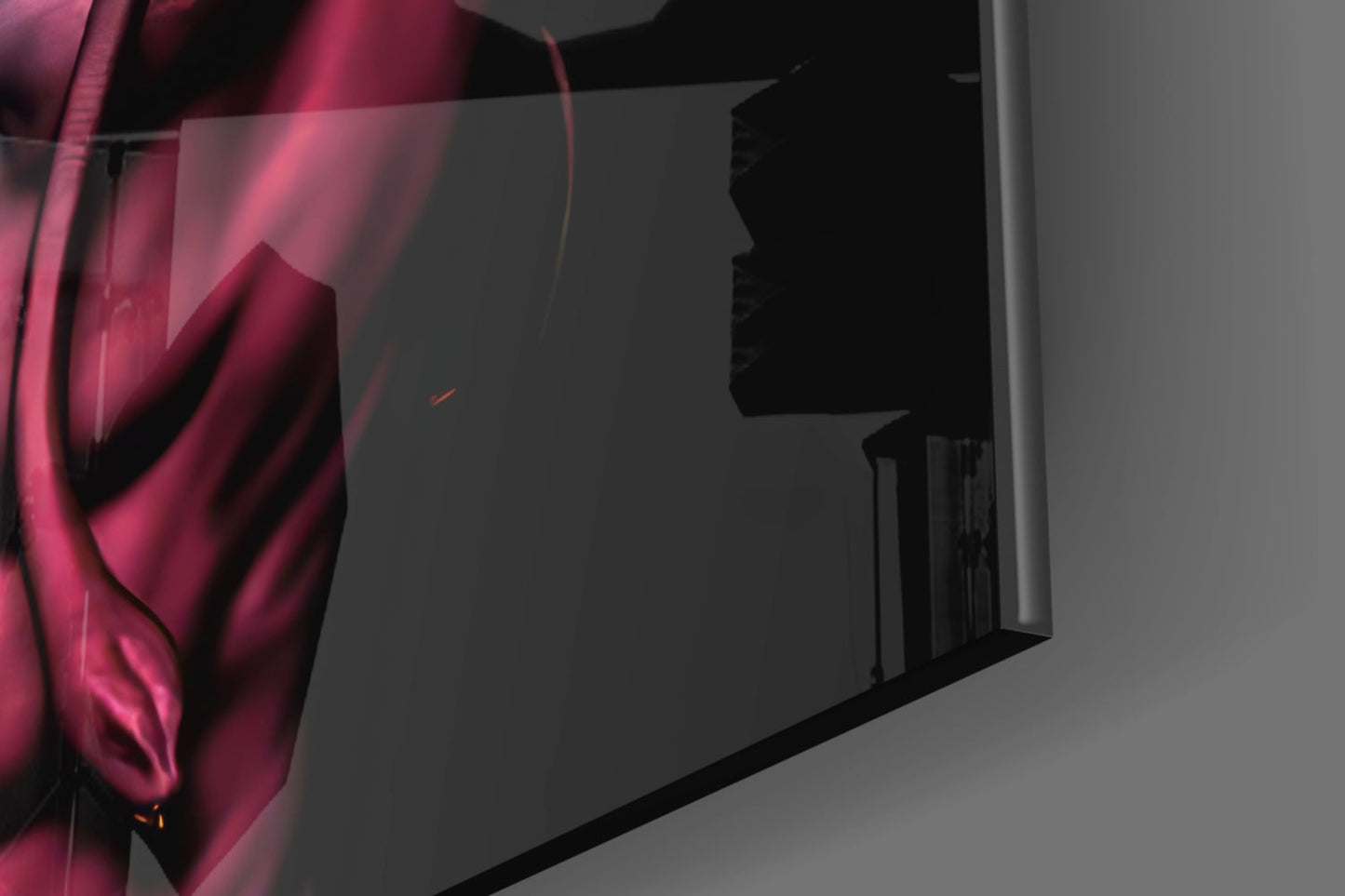 Close-up of magenta and pink glass wall art with silhouette profile detail, mounted on gray wall with dramatic side lighting.