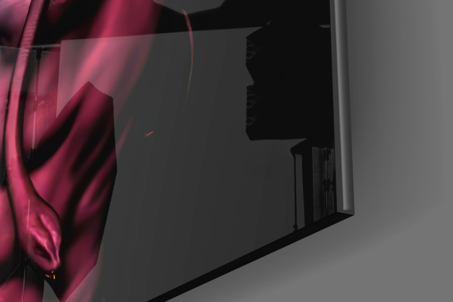 Close-up of magenta and pink glass wall art with silhouette profile detail, mounted on gray wall with dramatic side lighting.