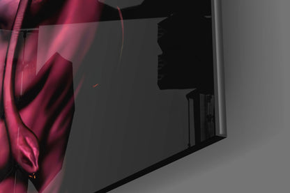 Close-up of magenta and pink glass wall art with silhouette profile detail, mounted on gray wall with dramatic side lighting.