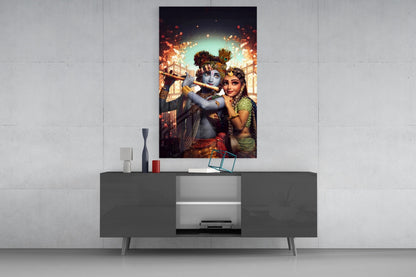 Krishna and Radha glass wall art mounted above a gray media console, depicting blue Krishna with flute and Radha in green sari against golden architectural backdrop.