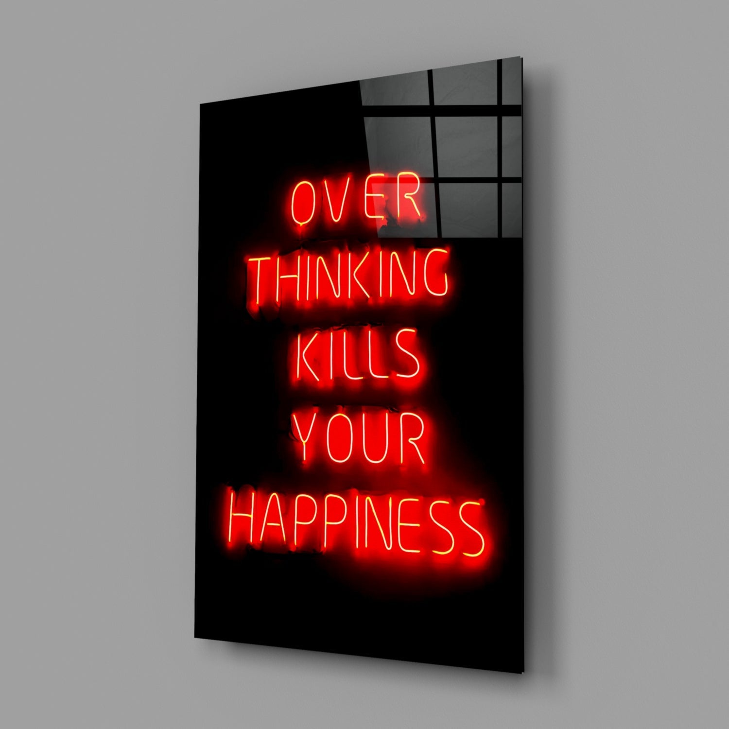 Red neon text reading "OVER THINKING KILLS YOUR HAPPINESS" displayed on black glass panel against gray background.