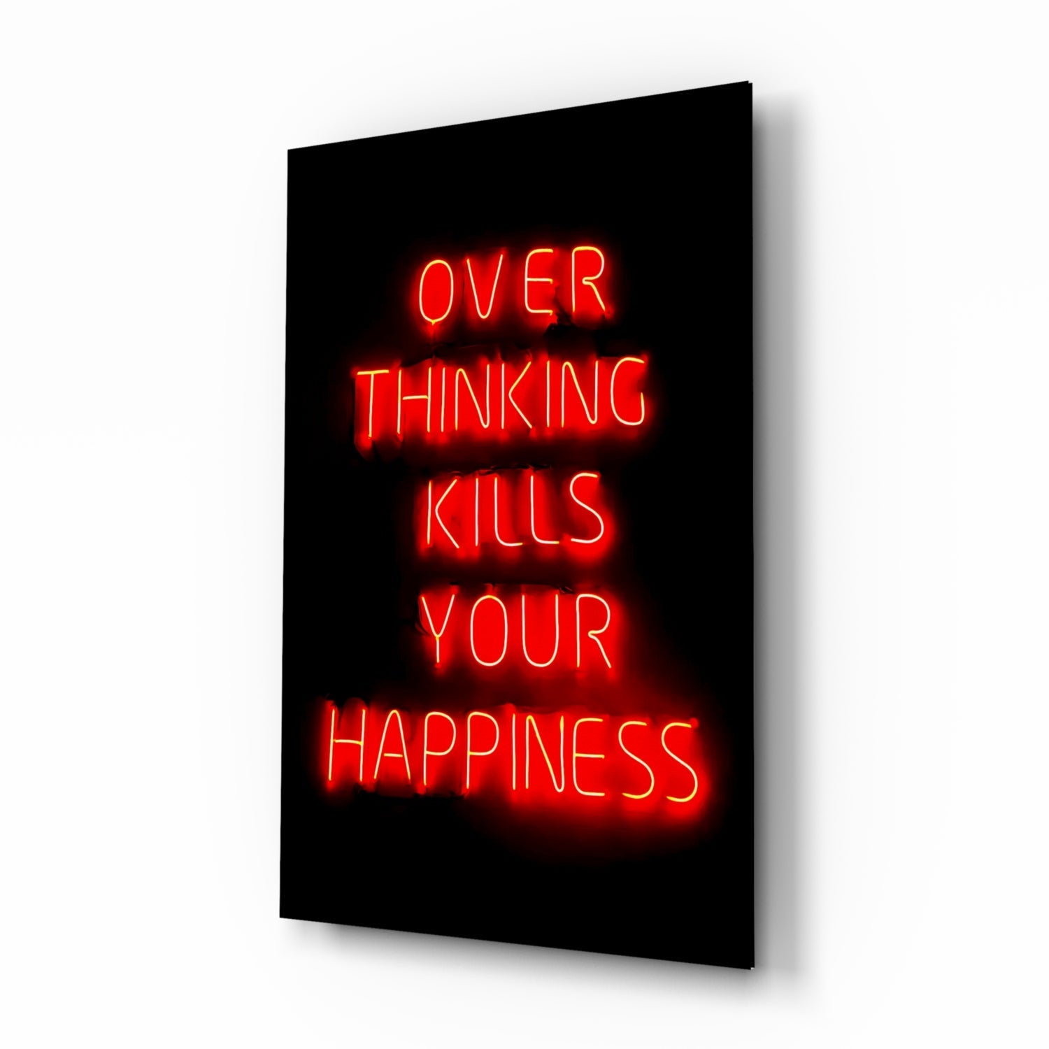 Red neon text reading "OVER THINKING KILLS YOUR HAPPINESS" glowing on black glass panel displayed at an angle.