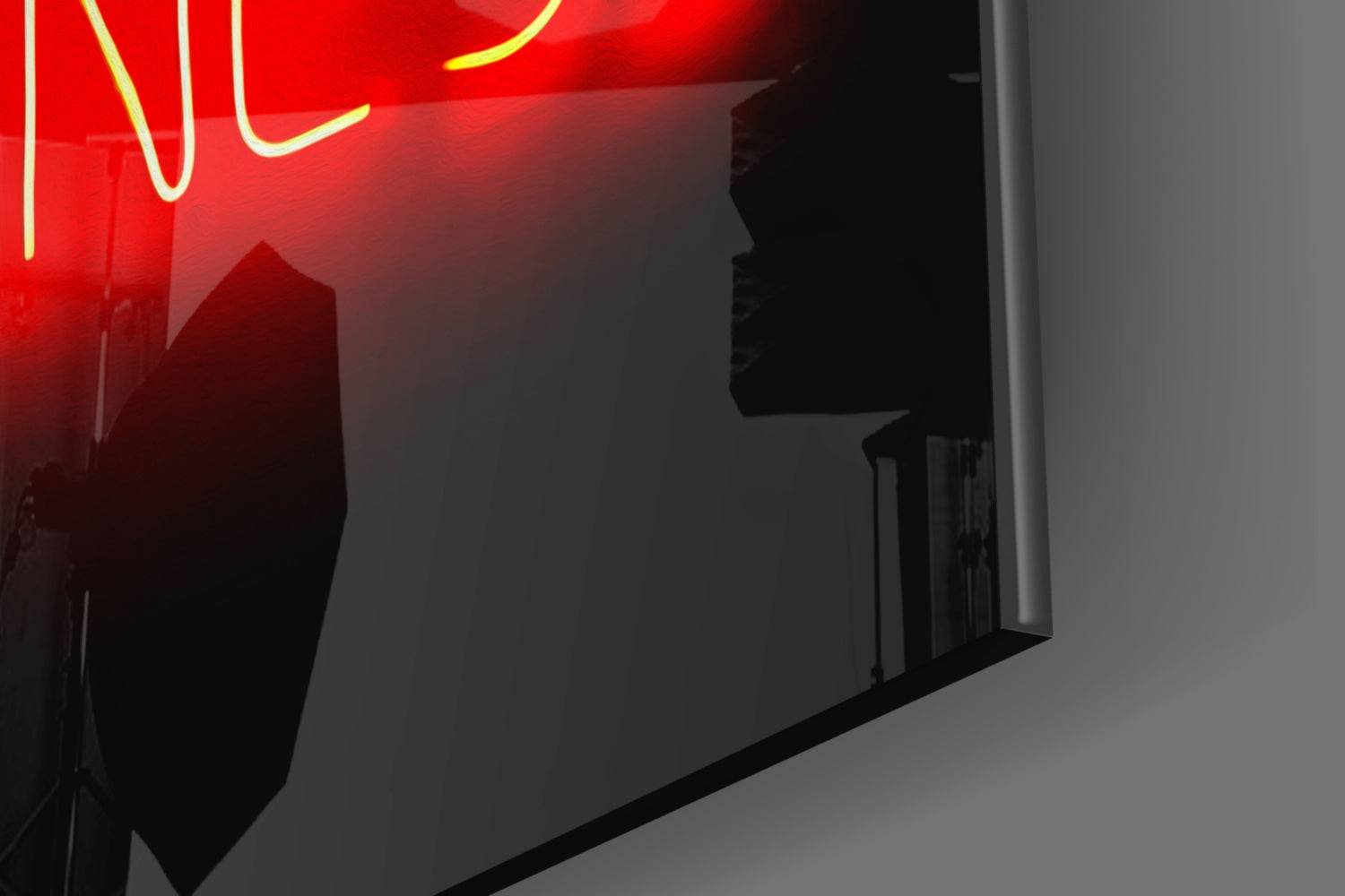 Red and yellow neon sign mounted on frosted glass wall panel, photographed at angle showing silhouette and glow.