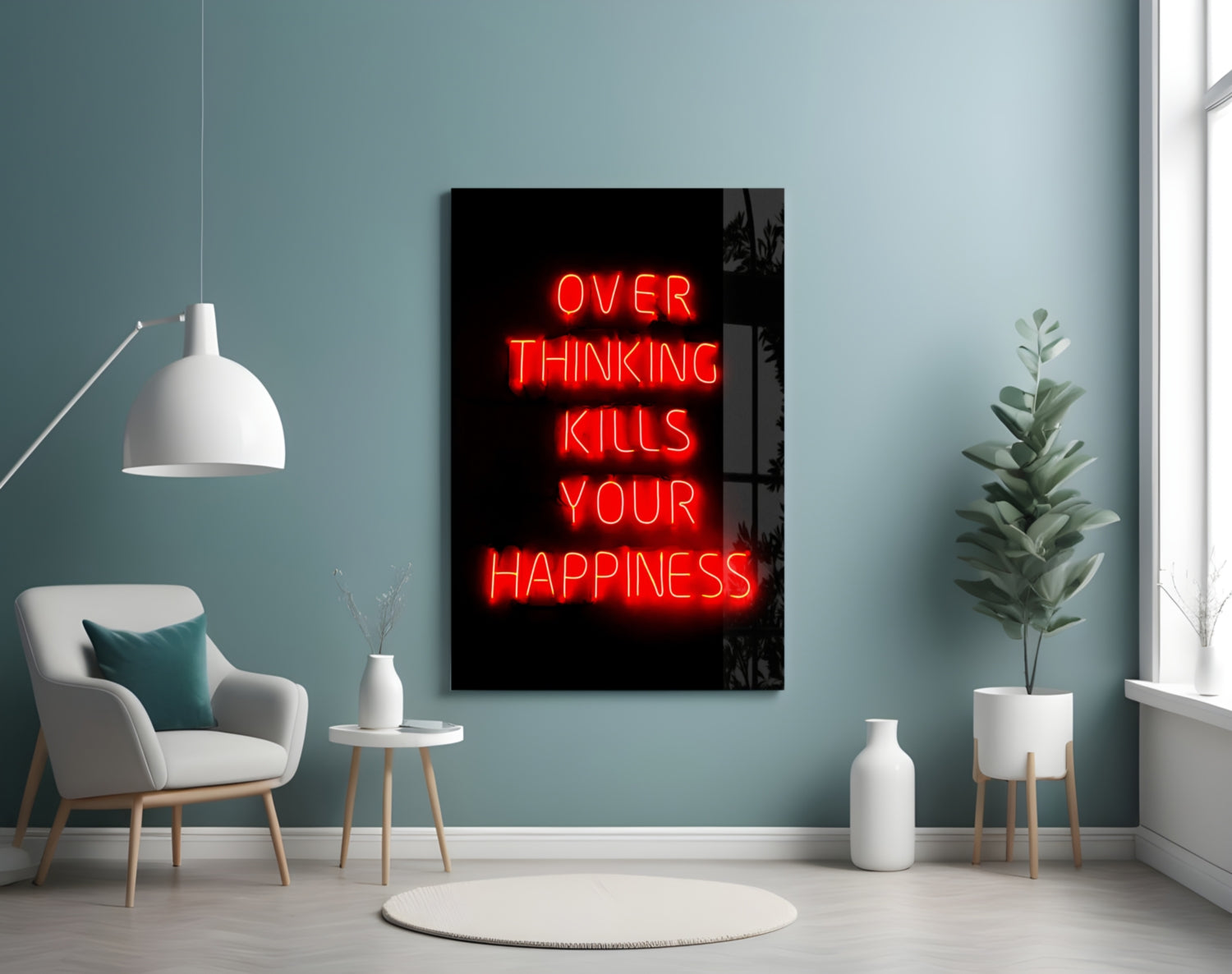 Red neon "OVER THINKING KILLS YOUR HAPPINESS" text on black glass panel displayed on teal wall beside chair and plant.