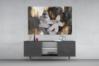 Modern living room setting displaying Gipsy Beauty glass wall art above dark console table, featuring portrait with gold and gray tones.