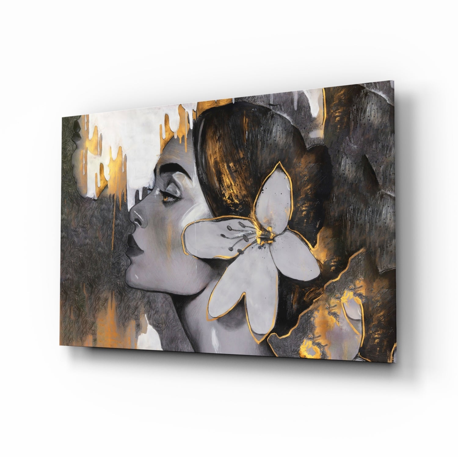 Angled perspective of glass wall art featuring a woman's profile with white flower and gold-outlined details against textured gray and gold background.