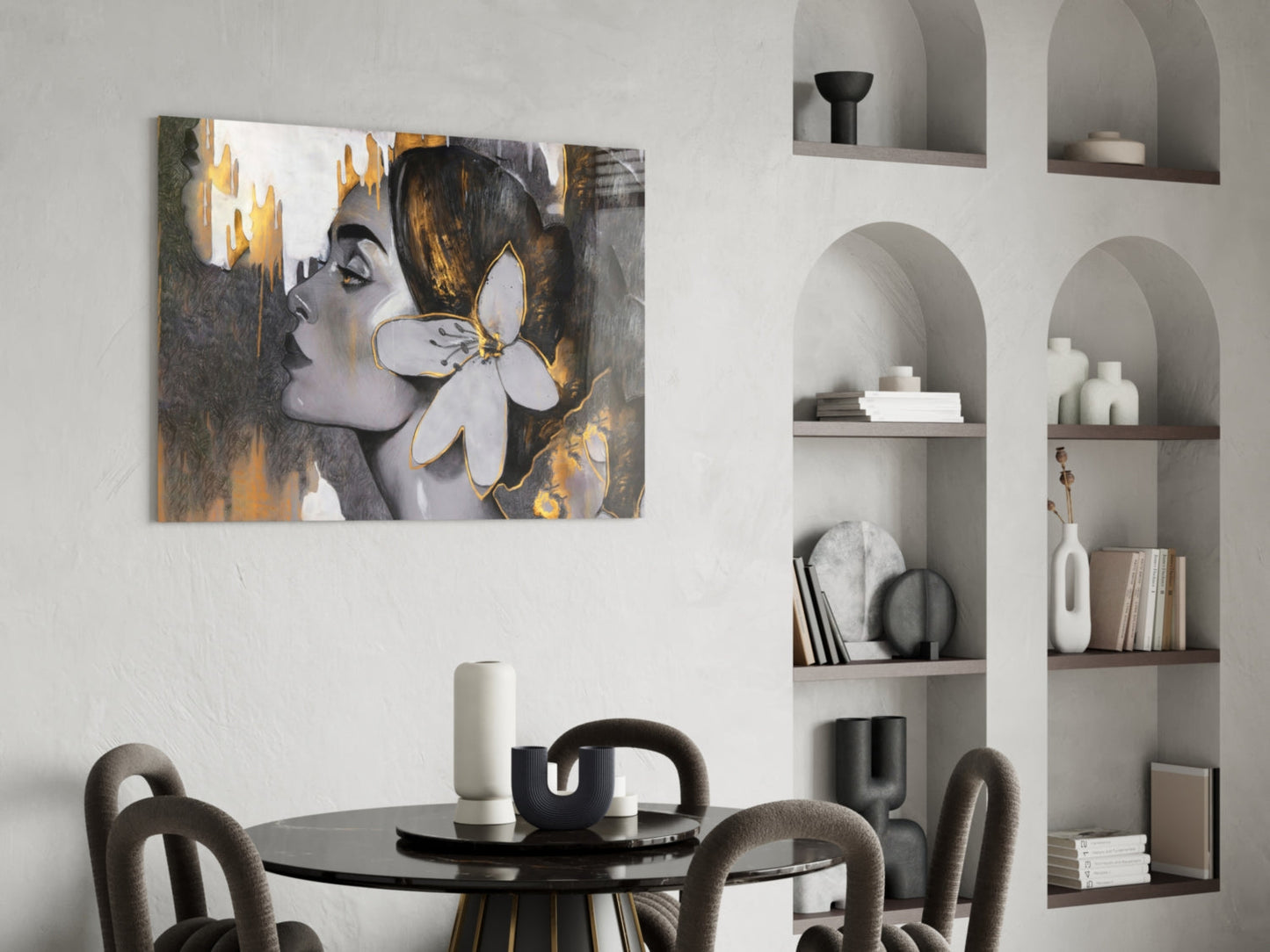 Glass wall art depicting a woman's profile with gold and gray tones and a white flower, displayed in a modern dining room.