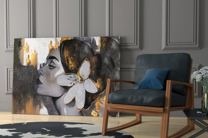 Glass wall art featuring a woman's profile with gold and black paint strokes and white flower detail displayed in modern living room setting.