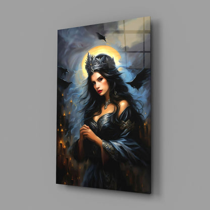 Dark-haired woman in black ornate armor and crown with glowing golden halo, mounted on glass against gray wall.