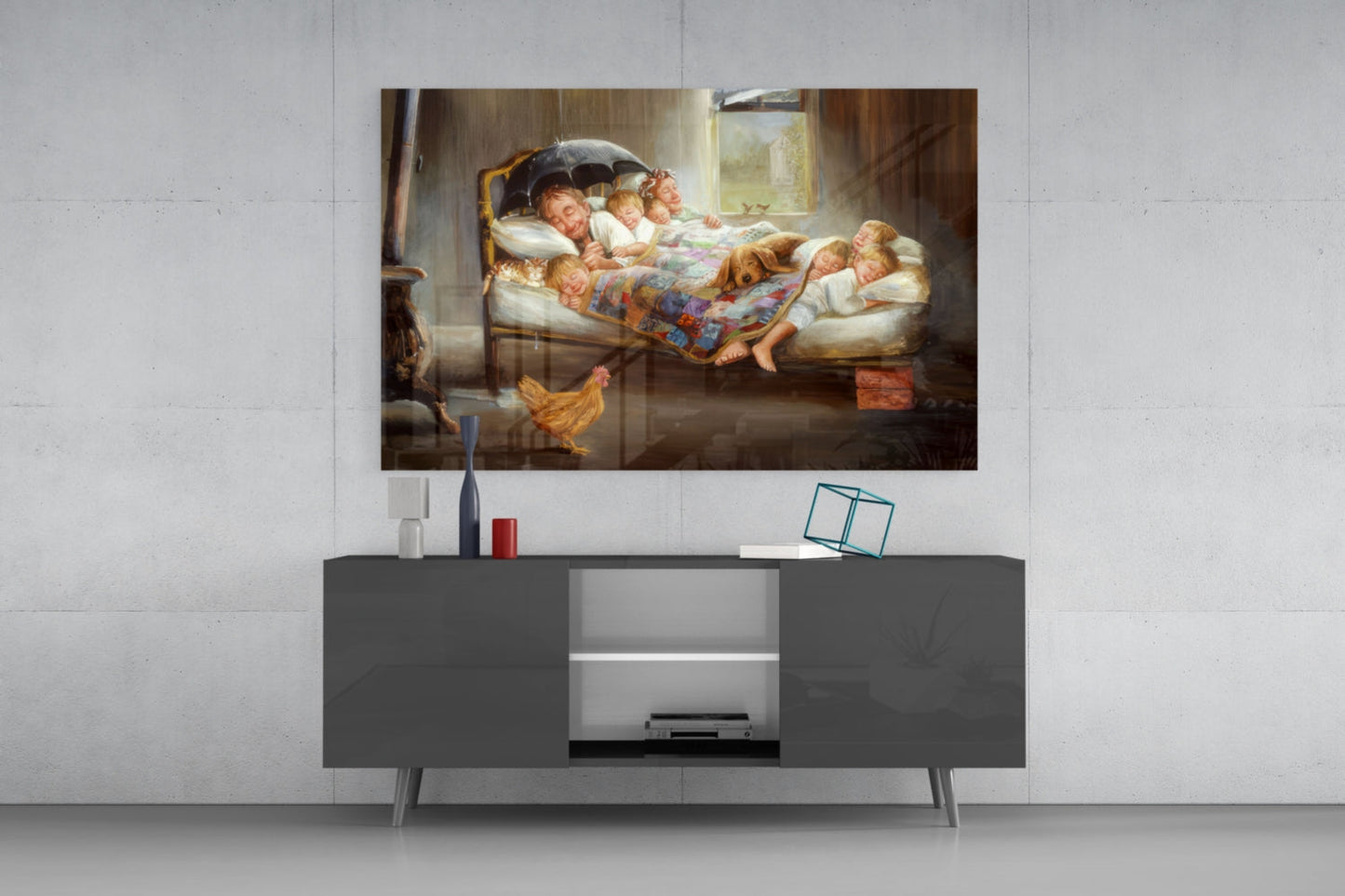 Glass wall art depicting a woman with children in bed under an umbrella, displayed above a modern dark gray media console in a minimalist room setting.