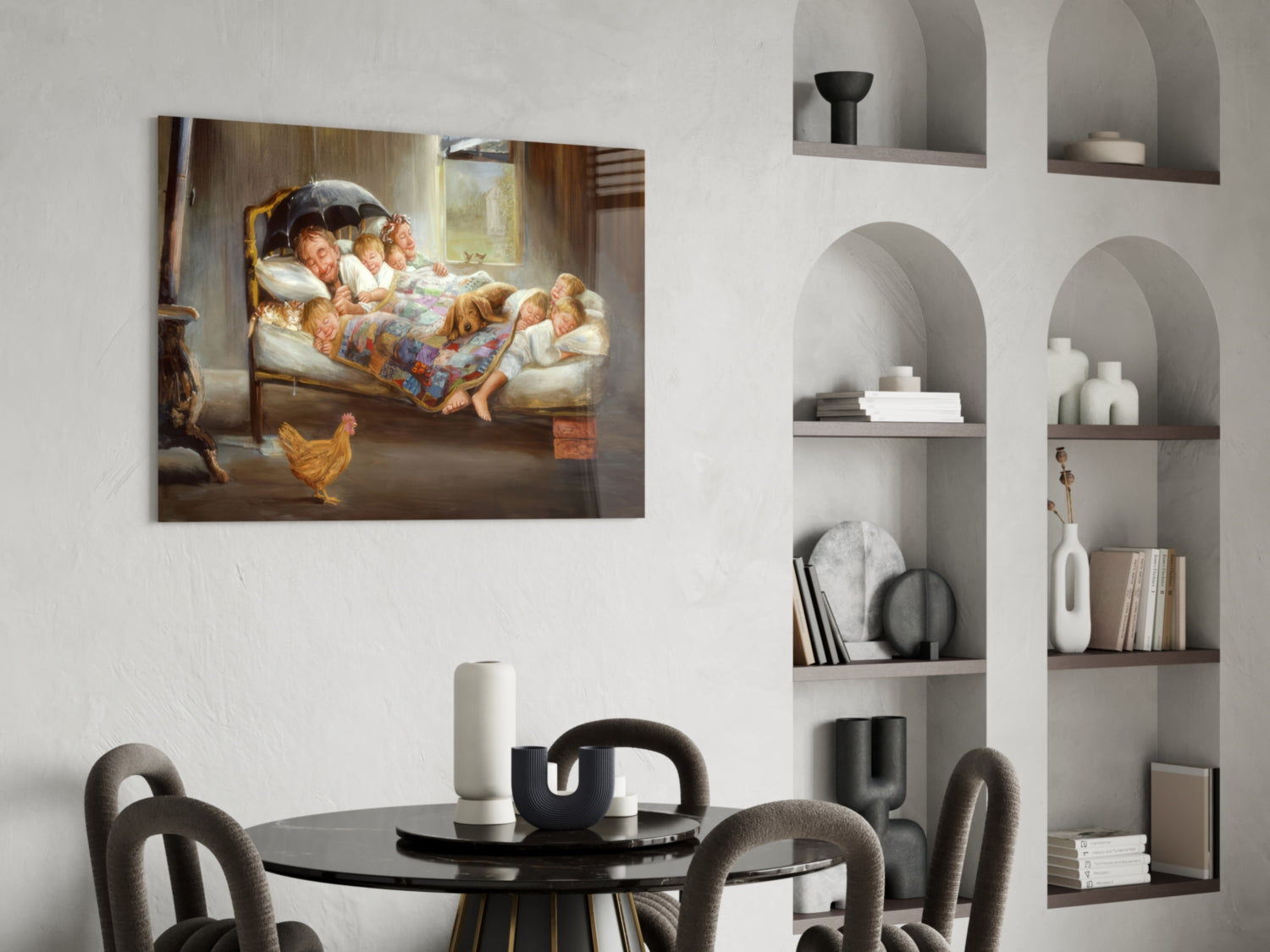 Glass wall art depicting a woman and children in bed with a rooster, displayed above a black round dining table in a modern interior with built-in shelving.