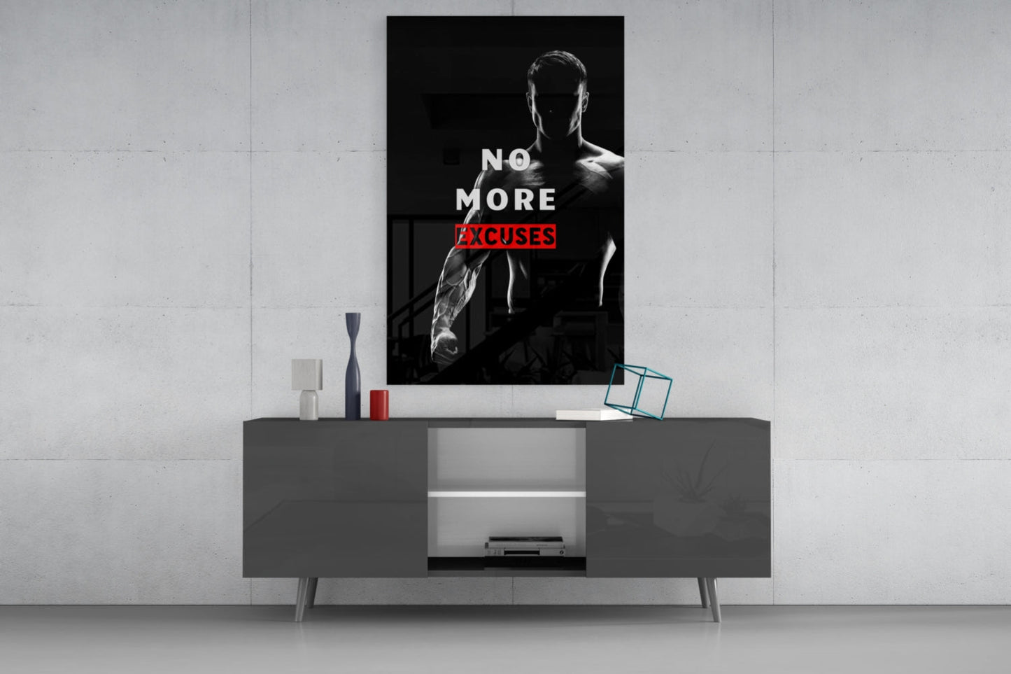 Black and white glass wall art featuring a muscular man with text "NO MORE EXCUSES" in red, displayed above a dark console table.