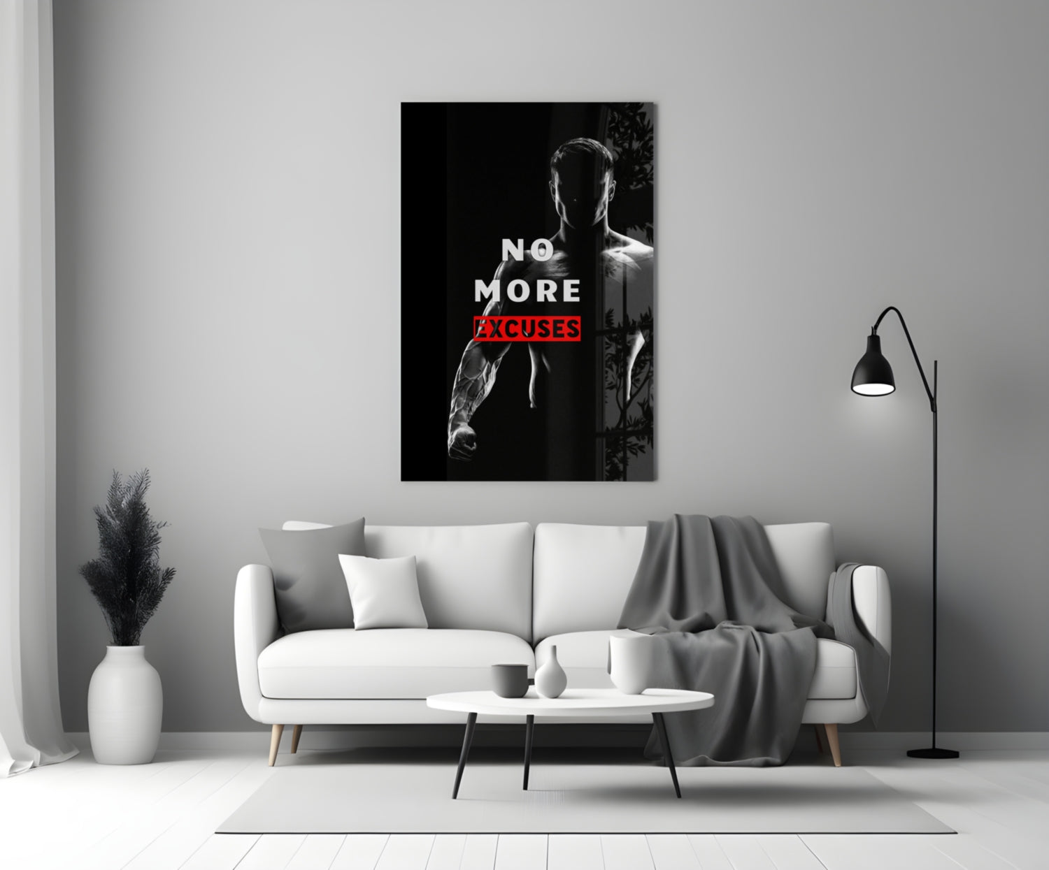 No More Excuses" glass wall art displayed above white sofa in minimalist living room setting with black floor lamp and white vase.