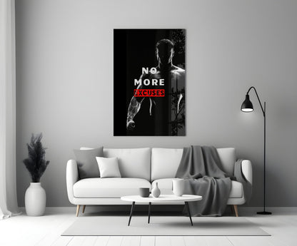 No More Excuses" glass wall art displayed above white sofa in minimalist living room setting with black floor lamp and white vase.