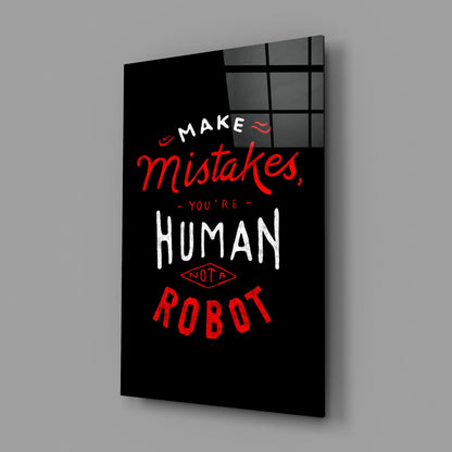 Black glass wall art panel with red and white text reading "Make mistakes, you're human not a robot" displayed at an angle against gray background.