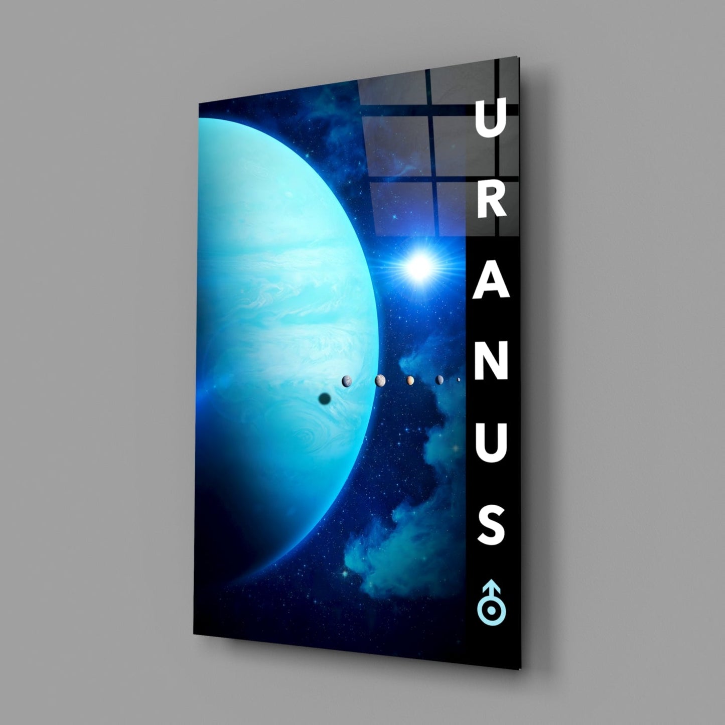 Angled view of glass wall art featuring a luminous blue planet, distant star, and orbital planets with "URANUS" text on black side panel.