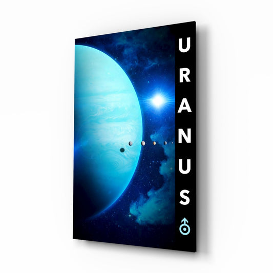 Angled view of glass wall art featuring a large turquoise planet with orbital moons and bright star against a deep blue starry background, with white "URANUS" text on black margin.