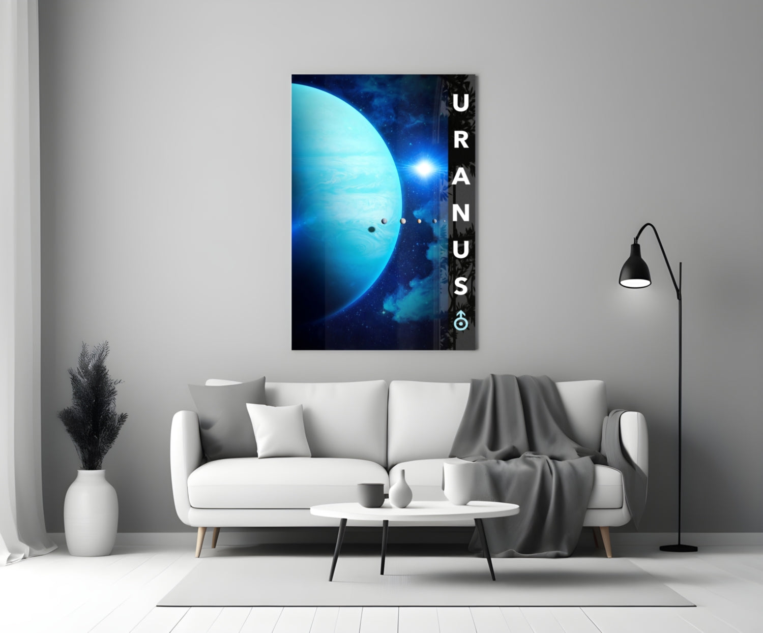 Uranus glass wall art depicting a bright blue planet with stars displayed above a white sofa in a minimalist living room.