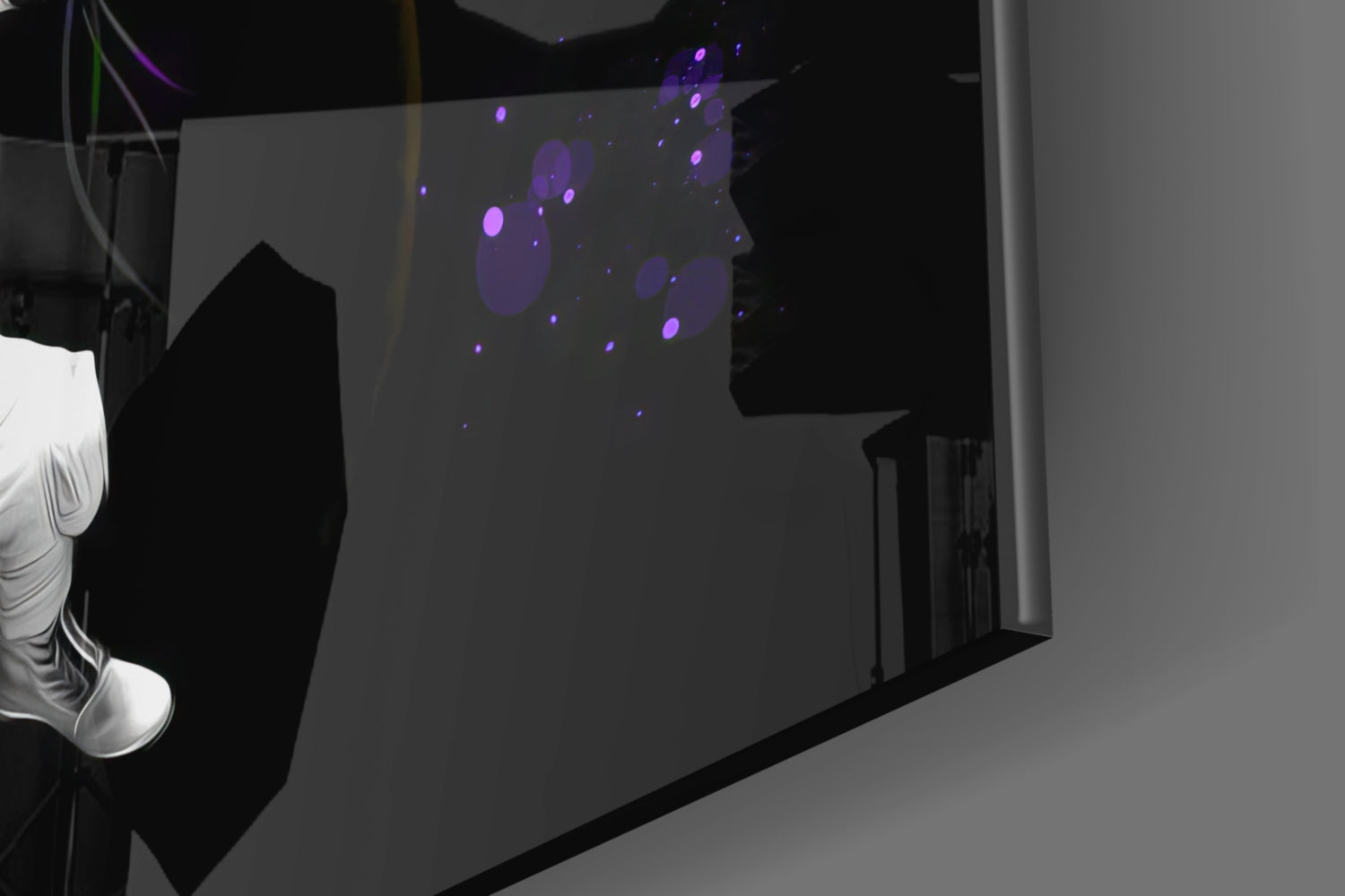Purple and blue illuminated circles displayed on frosted glass panel mounted on gray wall, viewed at angle.
