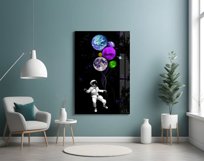Astronaut holding colorful planet balloons in space, displayed on wall in modern room with teal walls and white furniture.