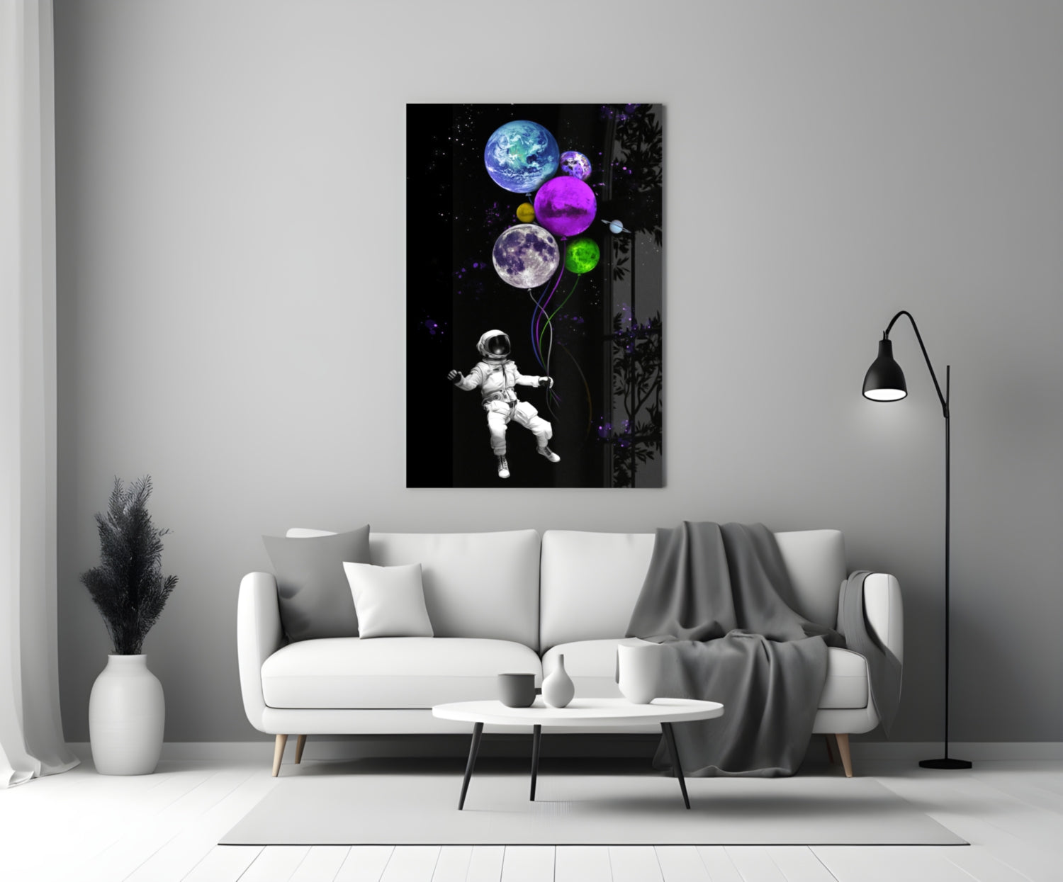 Modern living room with white sofa displaying colorful glass wall art of astronaut holding glowing planet balloons against black background.