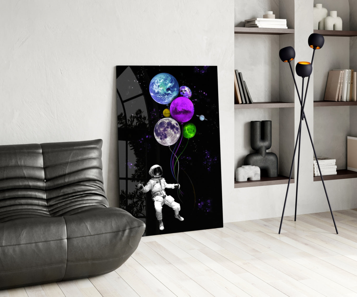 Modern living room interior with glass wall art featuring a colorful astronaut holding glowing planet balloons against black space background.