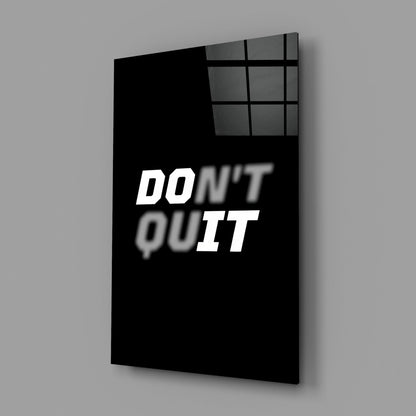 Black glass wall art panel with "DON'T QUIT" text in white, displayed at an angle against gray background.