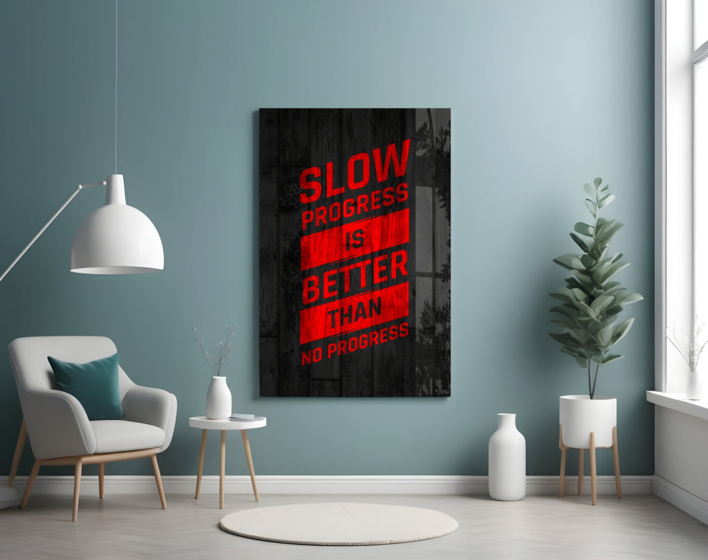 Modern room interior with motivational glass wall art featuring red text "Slow Progress Is Better Than No Progress" displayed above a cream armchair.