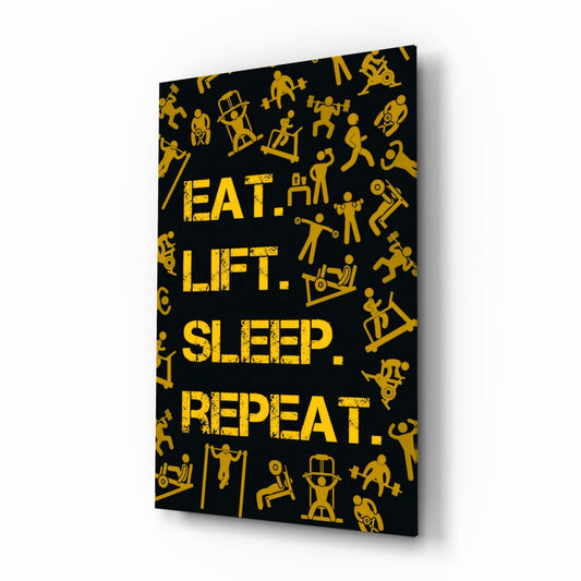 Black glass wall art panel with gold fitness icons and yellow distressed text reading "EAT. LIFT. SLEEP. REPEAT." displayed at an angle.