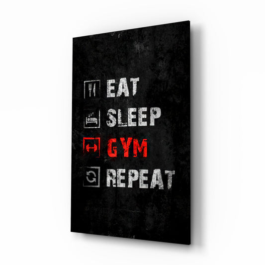 Black glass wall art panel displaying "Eat, Sleep, Gym, Repeat" text in white and red lettering with icons, angled perspective view.