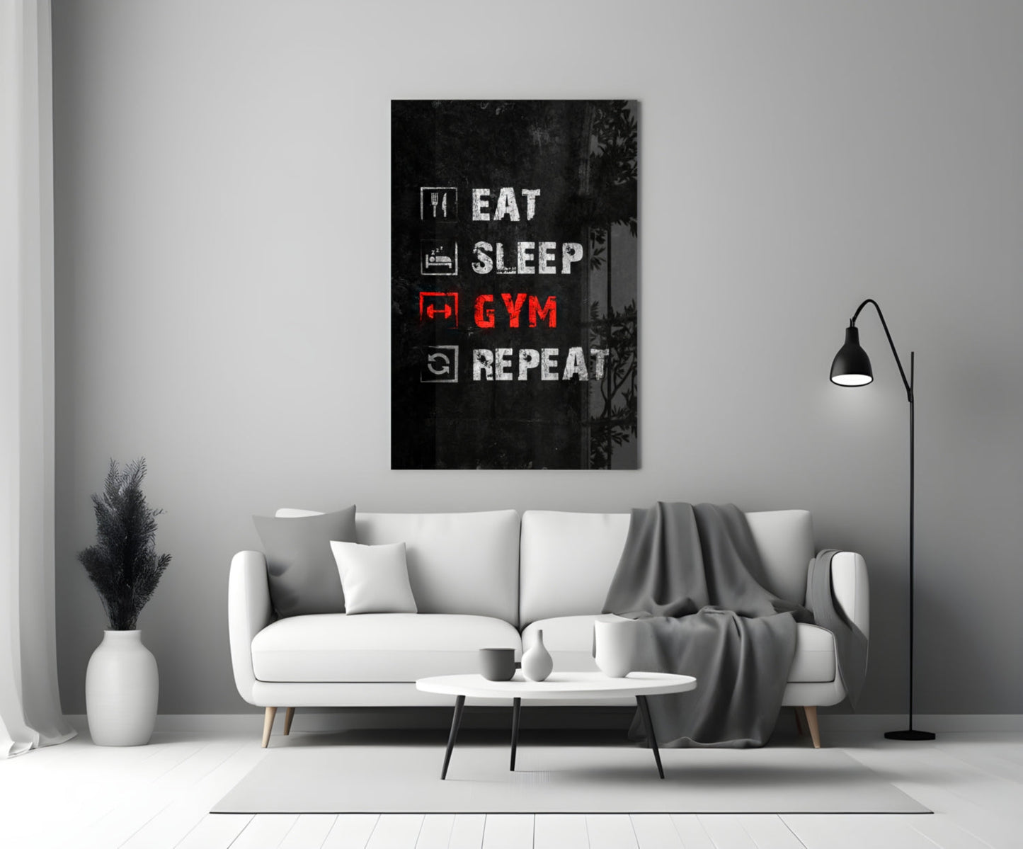 Black glass wall art with white and red neon-style text reading "Eat Sleep Gym Repeat" displayed above a white sofa in a modern living room.
