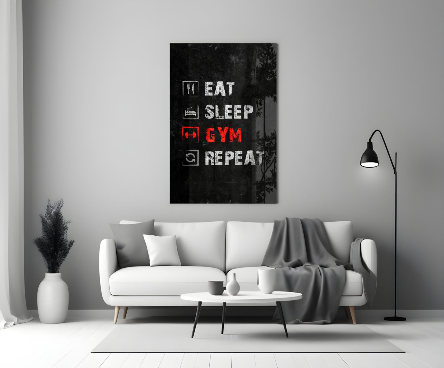 Black glass wall art with white and red neon-style text reading "Eat Sleep Gym Repeat" displayed above a white sofa in a modern living room.